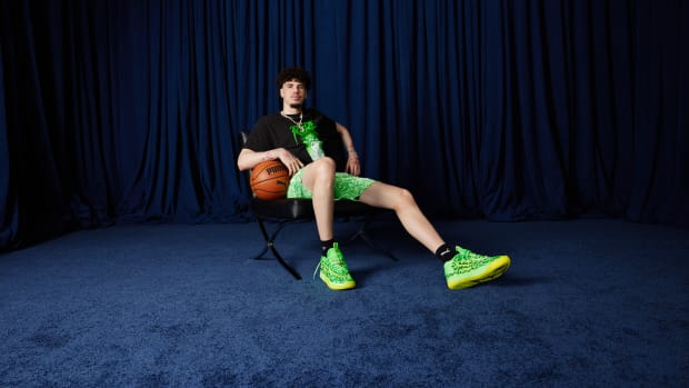 LaMelo Ball models green and black PUMA apparel.